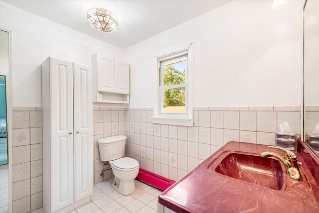 bathroom featuring vanity, tile walls, tile patterned floors, and toilet