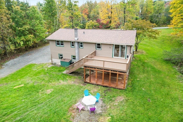 back of house featuring a wooden deck and a yard