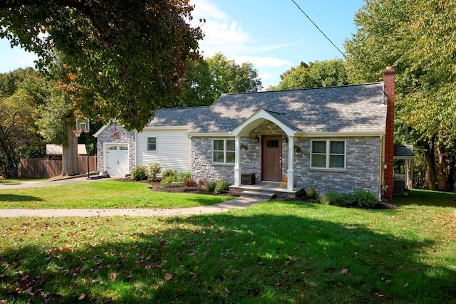 ranch-style home with a front yard, an attached garage, fence, and a chimney