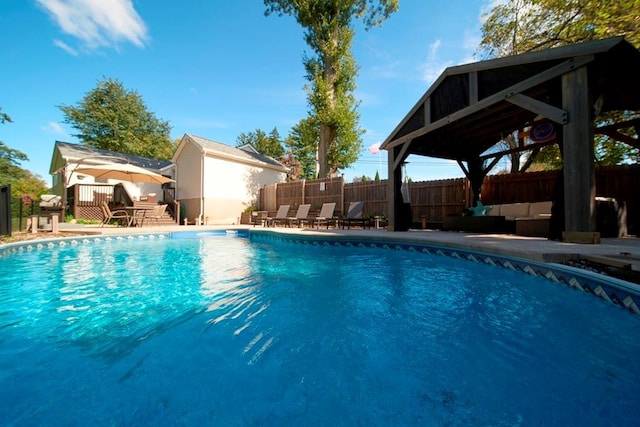 view of swimming pool with a patio, a fenced backyard, a fenced in pool, and a wooden deck