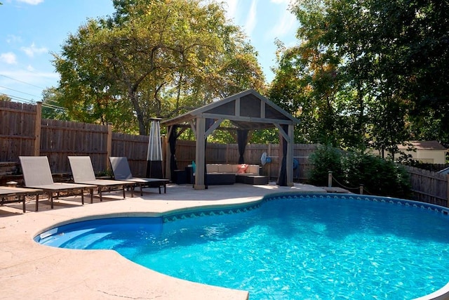 view of swimming pool with a patio area, a fenced in pool, a fenced backyard, and an outdoor hangout area