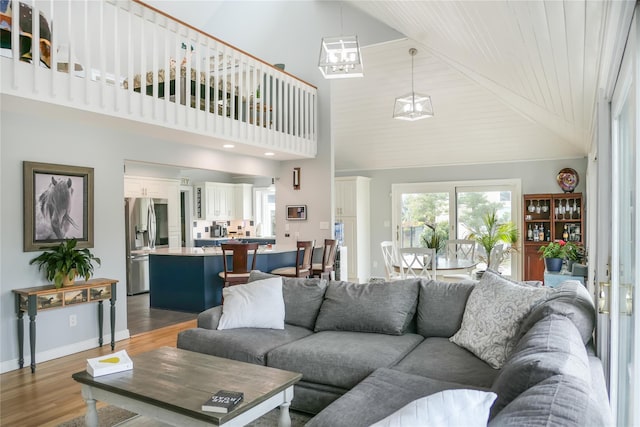 living room with hardwood / wood-style flooring and high vaulted ceiling