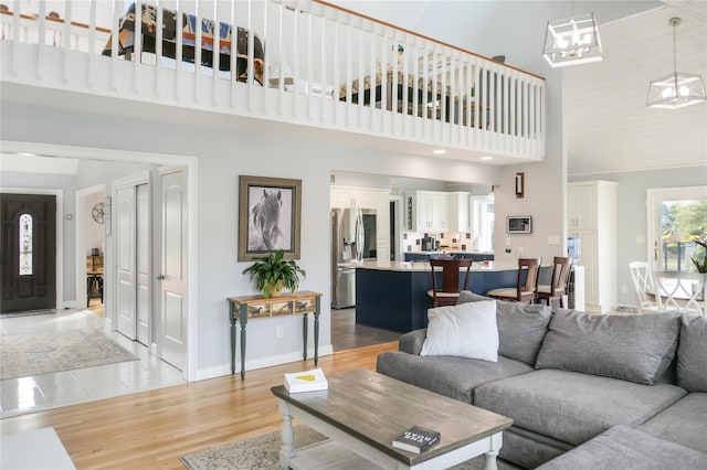 living room with a high ceiling and light wood-type flooring