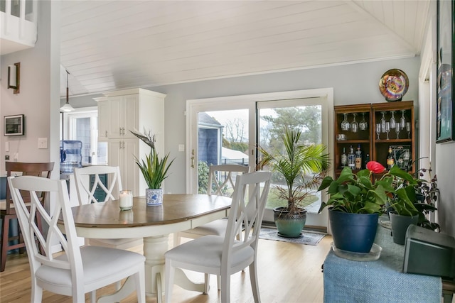 dining area featuring wood ceiling, vaulted ceiling, and light wood-type flooring