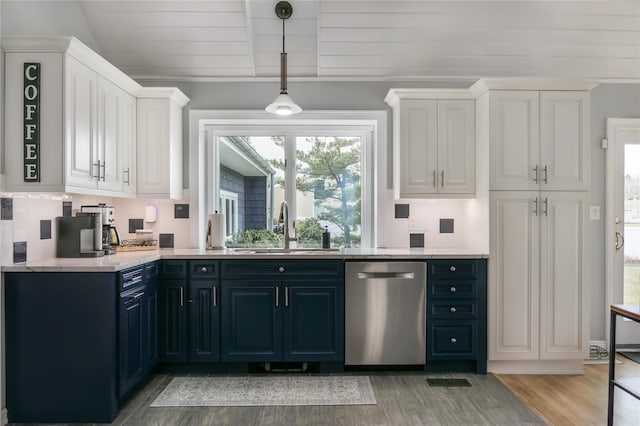 kitchen with sink, blue cabinetry, dishwasher, white cabinets, and vaulted ceiling