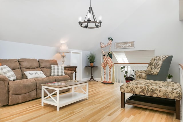 living room with an inviting chandelier, lofted ceiling, and hardwood / wood-style floors