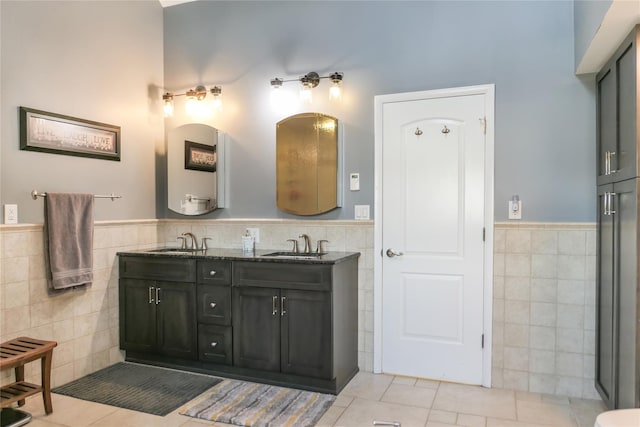 bathroom with tile walls, vanity, and tile patterned flooring