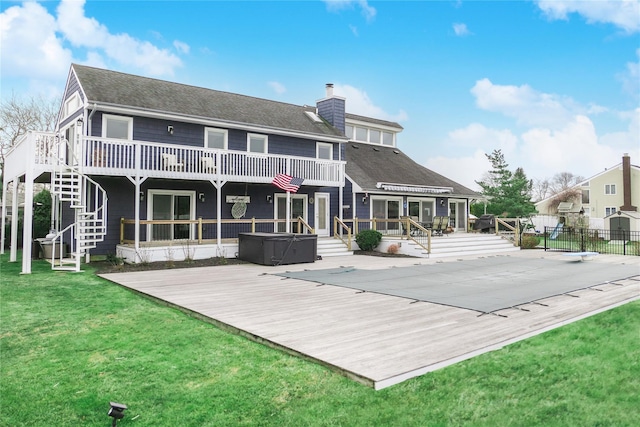 back of house featuring a pool side deck, a yard, and a patio area