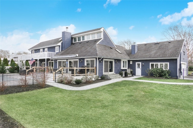 rear view of house featuring a yard