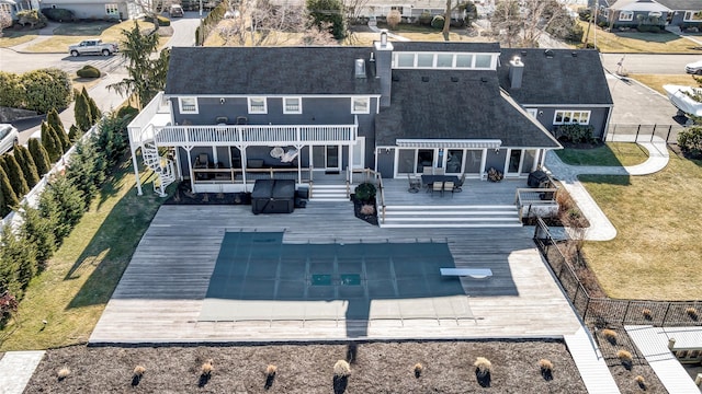 back of house with a swimming pool side deck and a patio