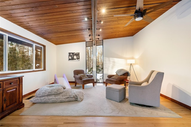 living area with wood ceiling, vaulted ceiling, ceiling fan, and light wood-type flooring