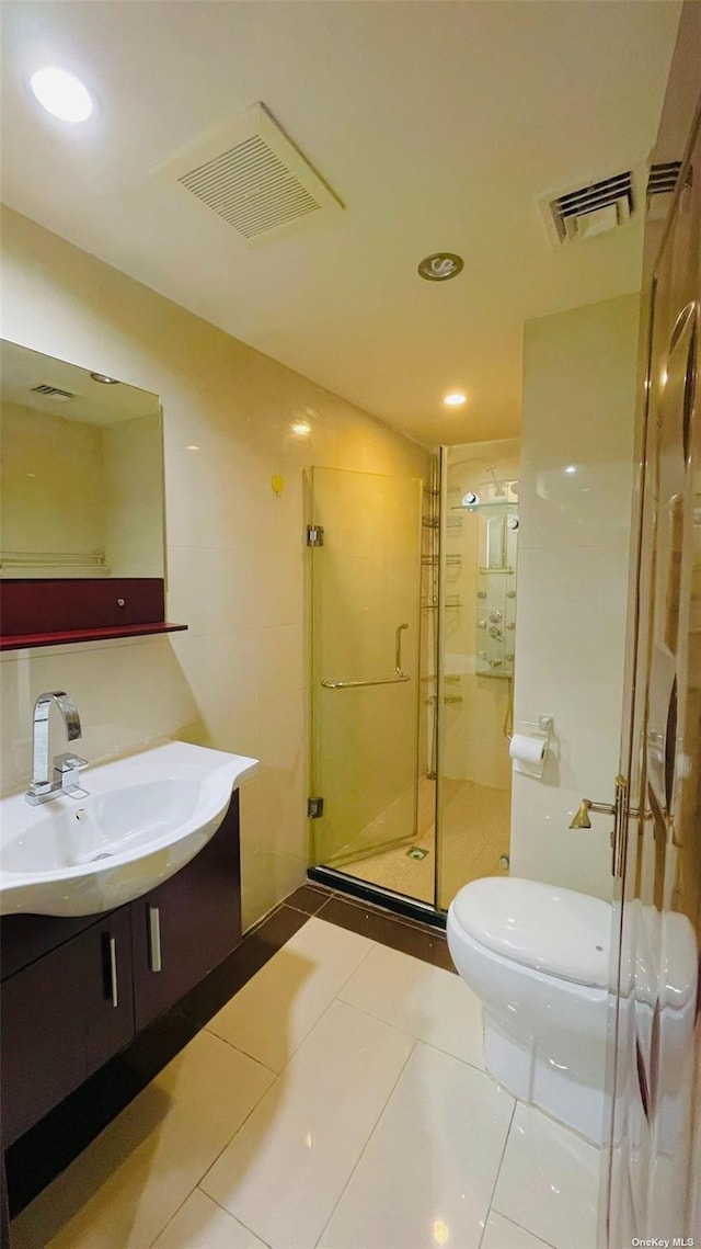 bathroom with vanity, tile patterned floors, toilet, and walk in shower