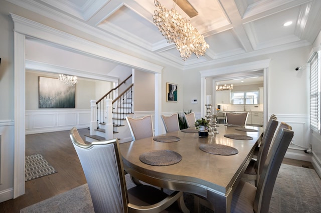 dining room with an inviting chandelier, coffered ceiling, dark hardwood / wood-style flooring, and beamed ceiling