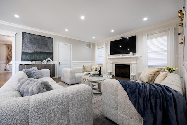 living room featuring ornamental molding and light hardwood / wood-style floors