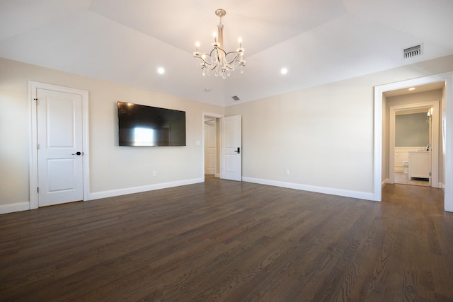 unfurnished living room featuring dark hardwood / wood-style flooring and a chandelier