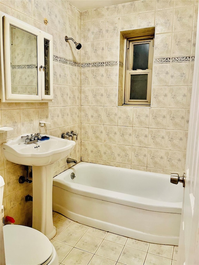 bathroom featuring toilet, bathing tub / shower combination, tile walls, and tile patterned floors