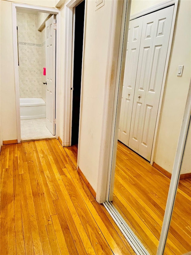 corridor with light wood-type flooring