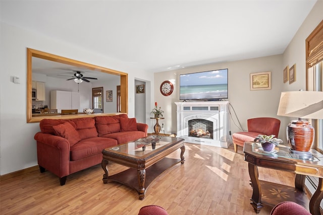 living room featuring baseboard heating and light wood-type flooring