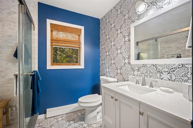 bathroom featuring tile patterned flooring, vanity, baseboard heating, toilet, and a shower with door