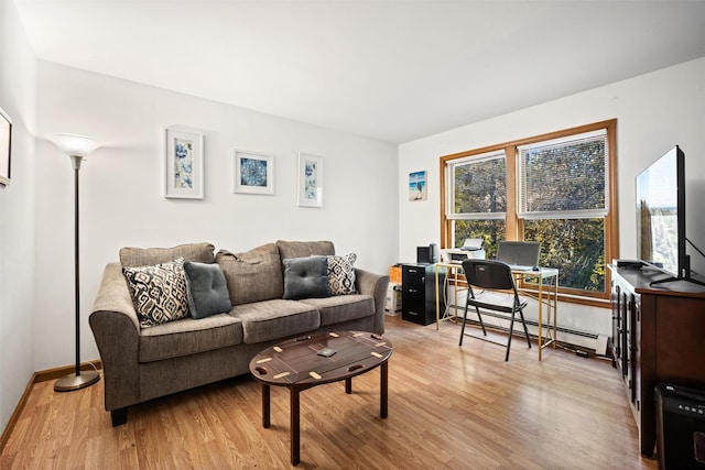 living room with baseboard heating and light hardwood / wood-style floors