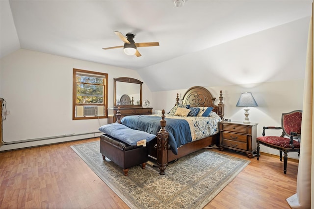 bedroom with lofted ceiling, a baseboard heating unit, and light hardwood / wood-style floors