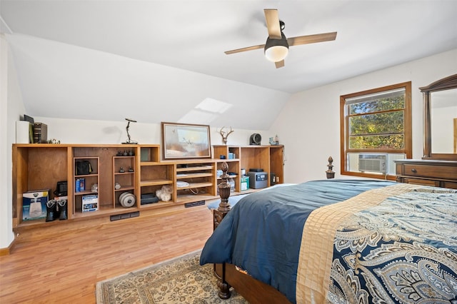 bedroom with ceiling fan, lofted ceiling, cooling unit, and light hardwood / wood-style floors