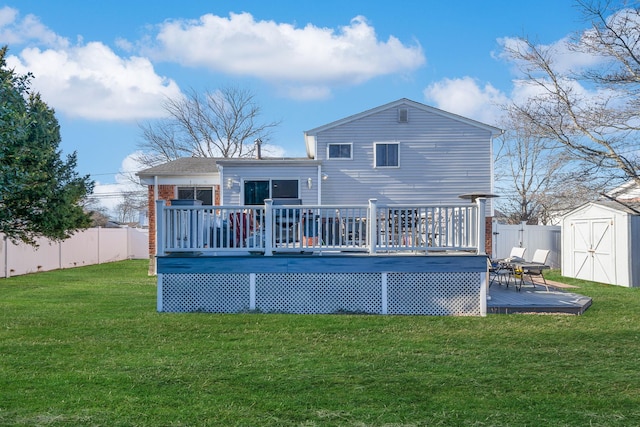 rear view of property featuring a storage shed, a deck, and a lawn