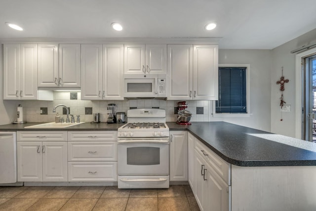 kitchen featuring white appliances, sink, and white cabinets