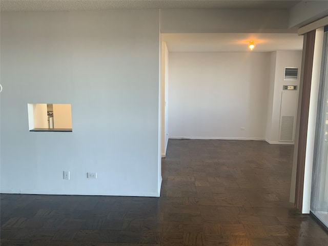 hallway with dark parquet flooring