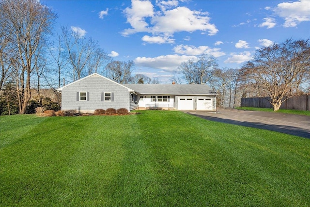 ranch-style home featuring a garage and a front yard