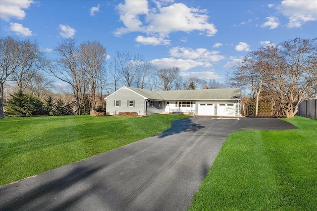 ranch-style house featuring a garage and a front yard