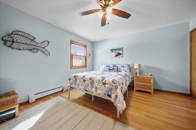 bedroom featuring a baseboard radiator, ceiling fan, and light hardwood / wood-style floors