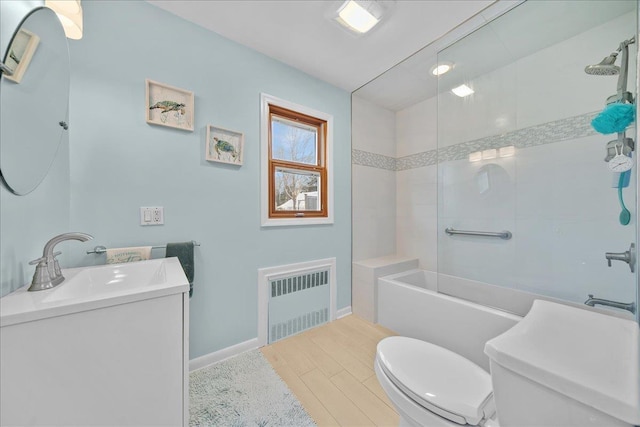 bathroom featuring radiator heating unit, toilet, and vanity