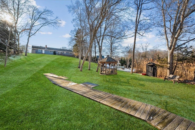 view of yard with a gazebo and a shed