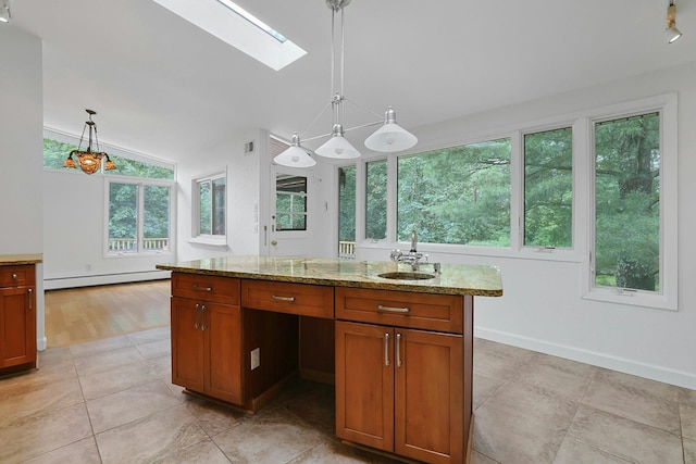 3 Dore Ct, New City, NY 10956 - kitchen with a baseboard heating unit, a skylight, light stone counters, vaulted ceiling, and hanging light fixtures