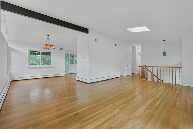 3 Dore Ct, New City, NY 10956 - unfurnished room featuring a skylight, light wood-style floors, beam ceiling, and a baseboard radiator