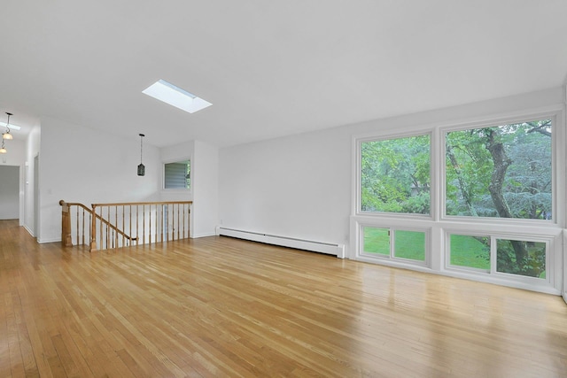 3 Dore Ct, New City, NY 10956 - empty room featuring baseboard heating, a skylight, light wood-style flooring, and lofted ceiling