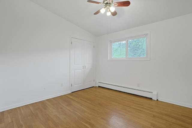 3 Dore Ct, New City, NY 10956 - unfurnished bedroom featuring a baseboard heating unit, light wood-style floors, vaulted ceiling, ceiling fan, and a closet