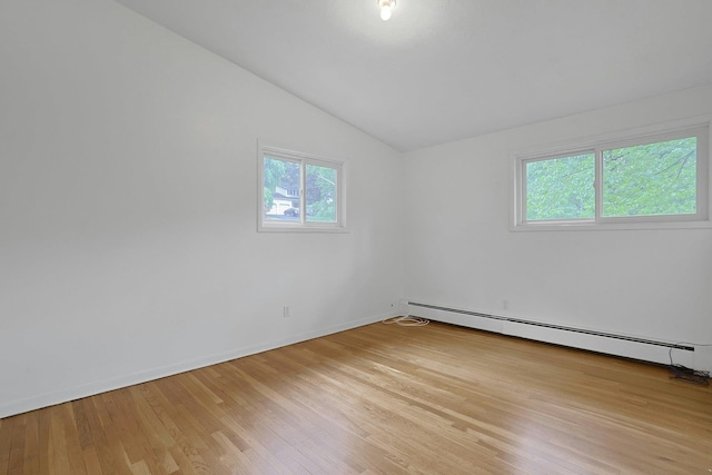 3 Dore Ct, New City, NY 10956 - unfurnished room featuring a baseboard radiator, vaulted ceiling, plenty of natural light, and light wood-style flooring