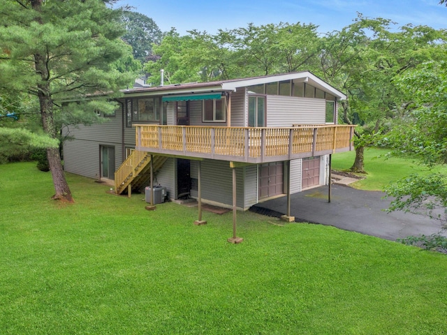 3 Dore Ct, New City, NY 10956 - rear view of house with stairs, a deck, a lawn, asphalt driveway, and an attached garage