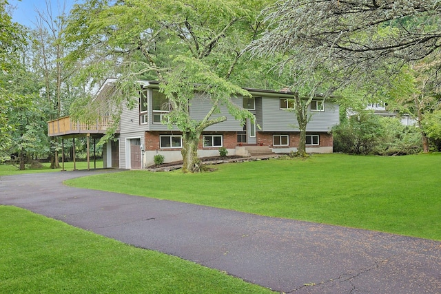3 Dore Ct, New City, NY 10956 - view of front of house featuring driveway, a garage, brick siding, and a front lawn
