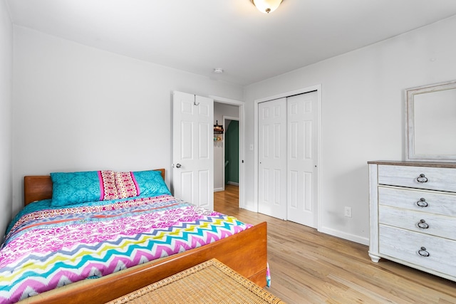 bedroom with light wood-type flooring and a closet