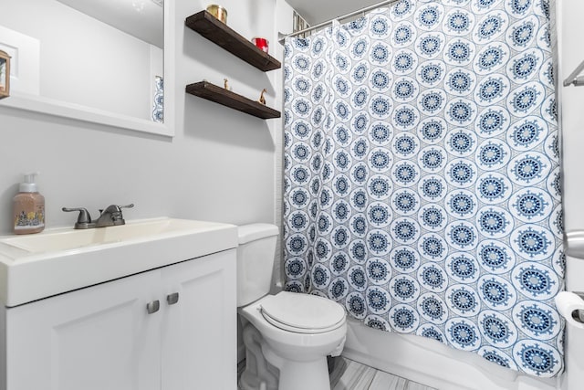 full bathroom featuring vanity, toilet, and shower / tub combo with curtain