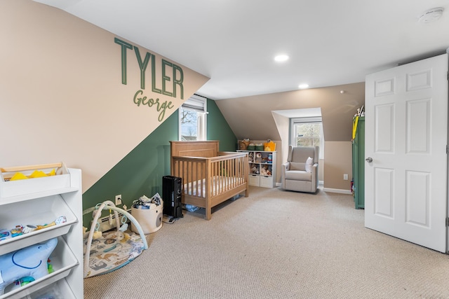 carpeted bedroom featuring a crib and lofted ceiling