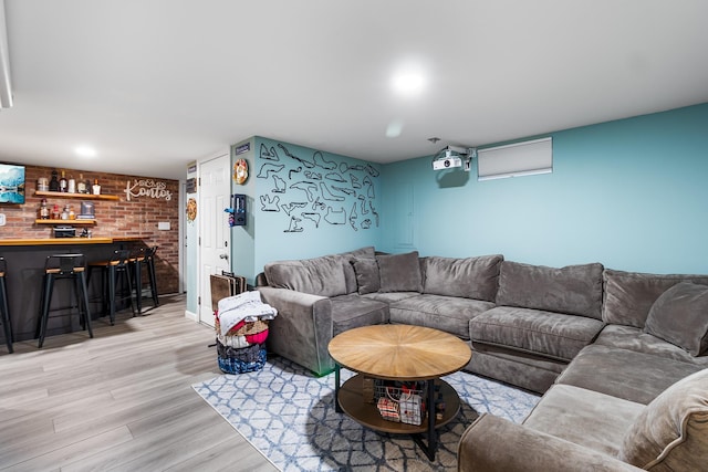 living room featuring bar area and light hardwood / wood-style flooring