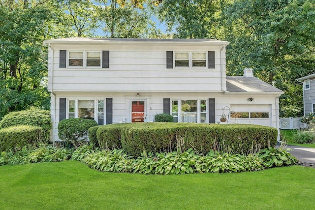 colonial inspired home with a front lawn