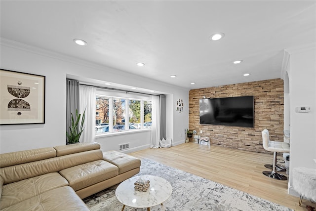 living room featuring ornamental molding and light hardwood / wood-style floors