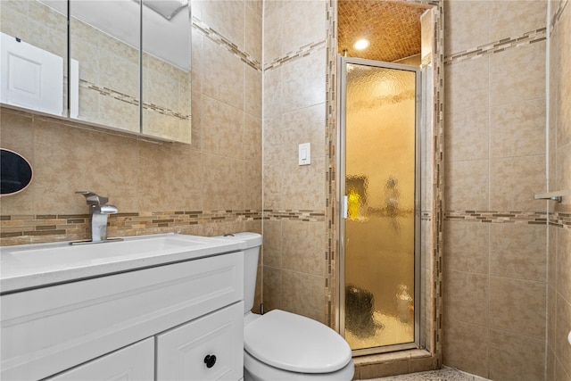 bathroom with vanity, tile walls, an enclosed shower, and toilet