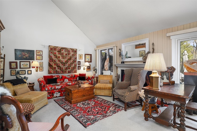 living area with high vaulted ceiling and carpet flooring