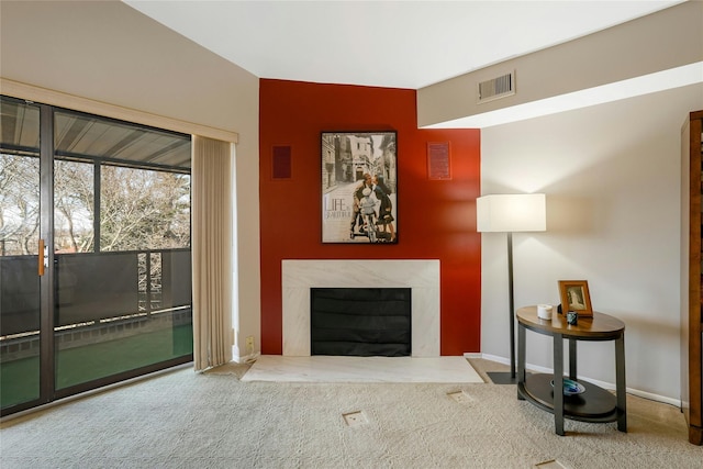 carpeted living room featuring a fireplace